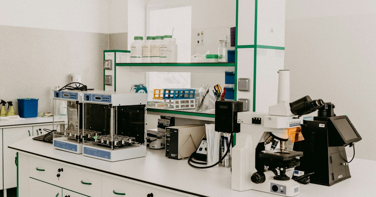Bancada de laboratório com microscópio e instrumentos de análise