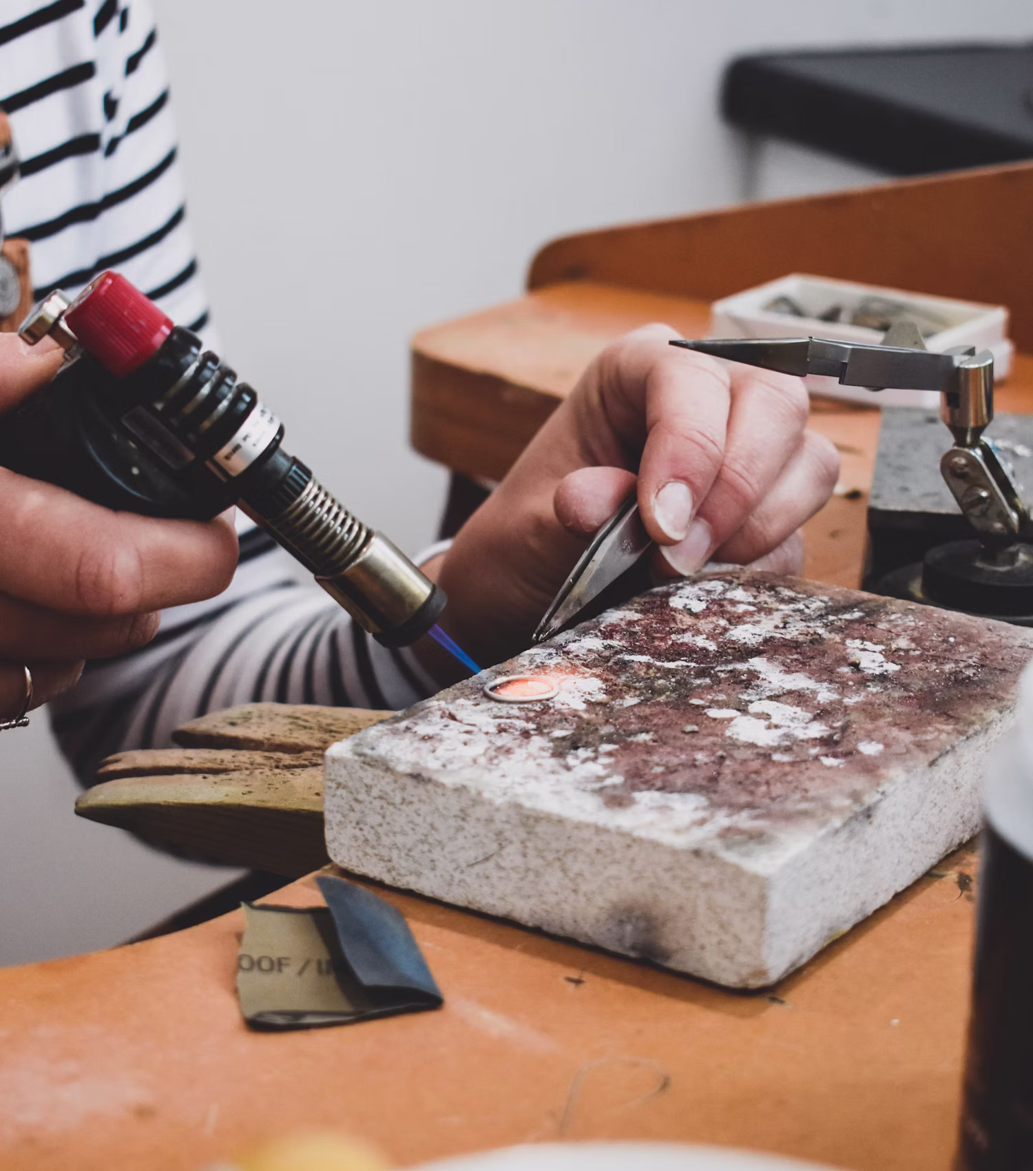 Stone setter inspecting a ring