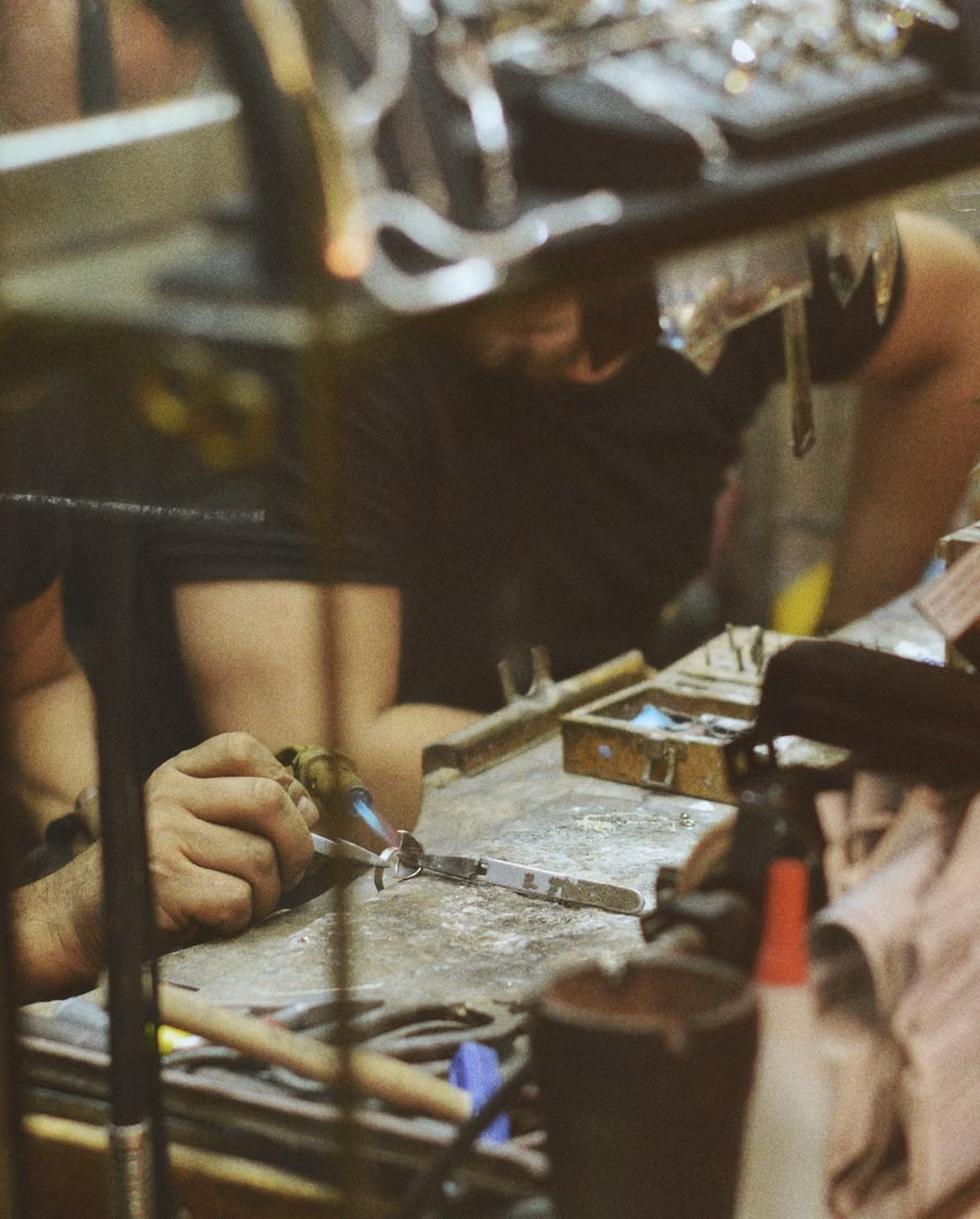 Illustrative reference of jewellers working at a bench