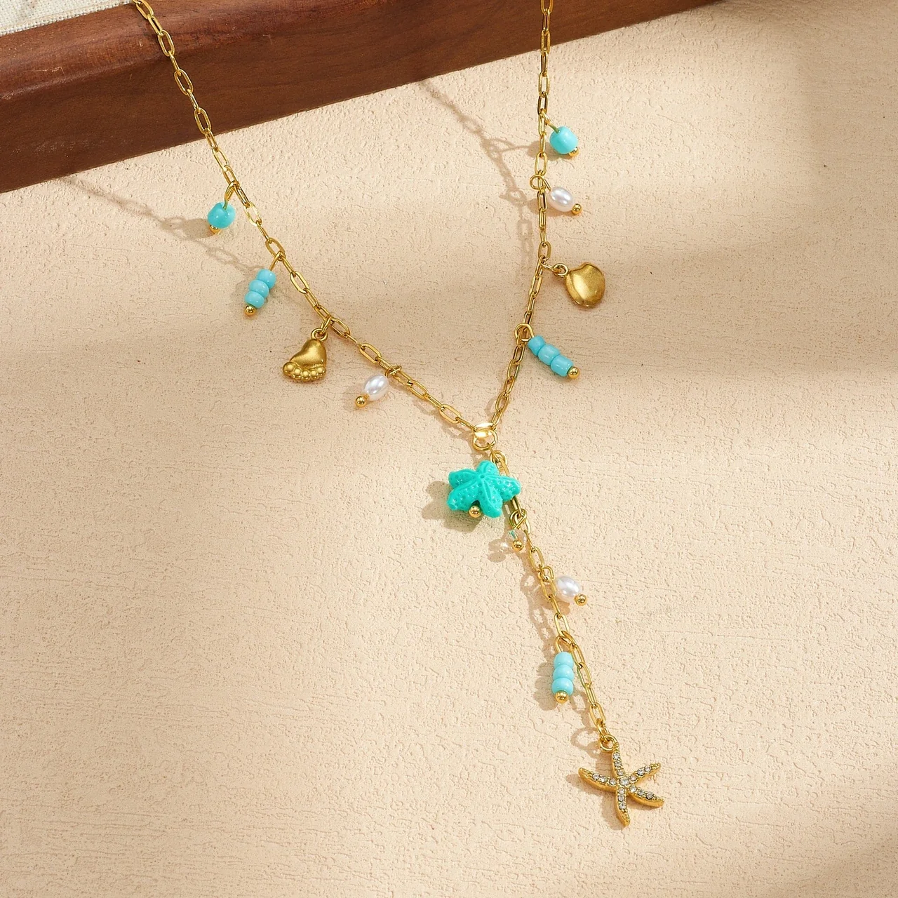 Y-ketting met bedels van zeeschildpad en schelp, verguld productfoto