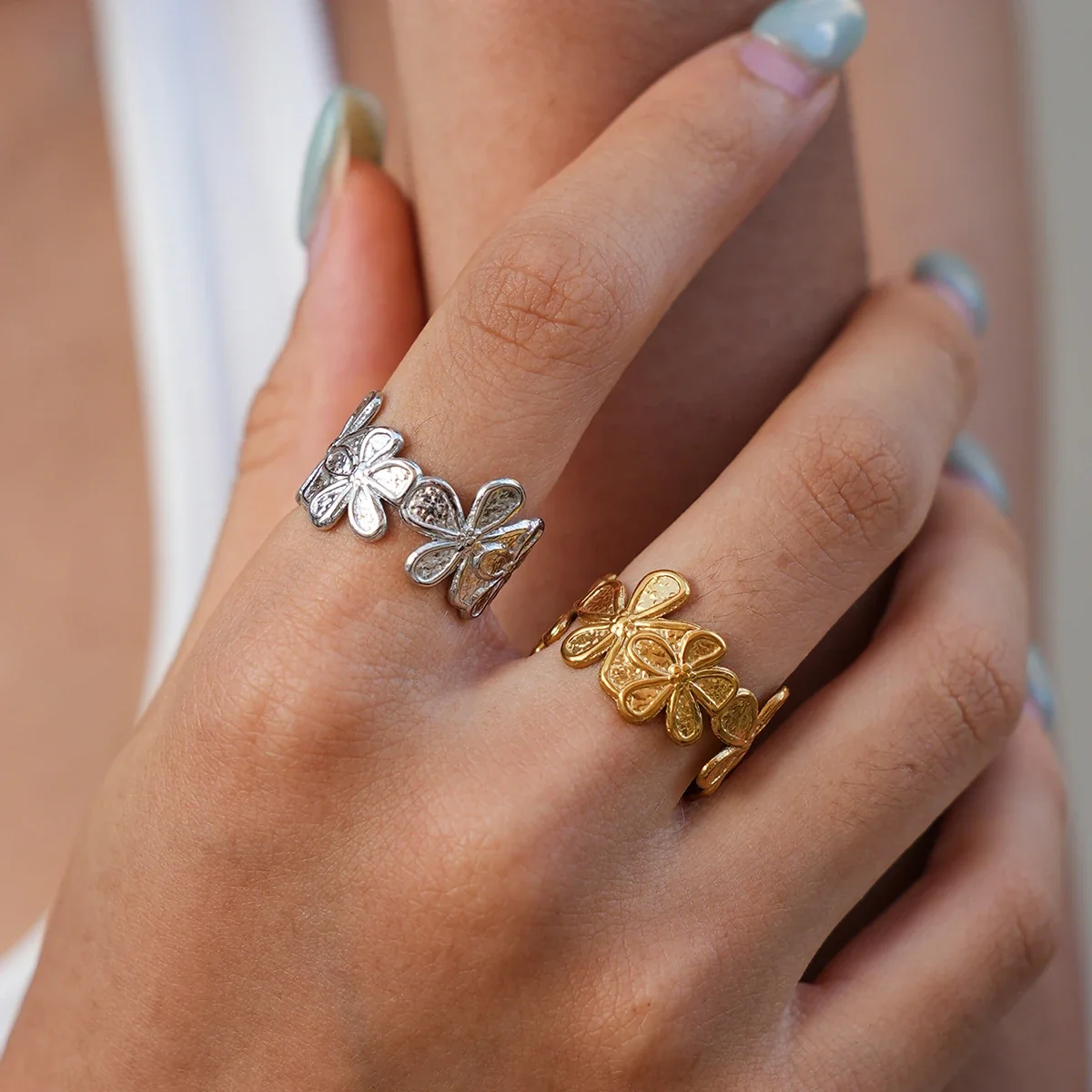 Open ring met vierbladige bloemen van roestvrij staal met goudkleurige PVD-afwerking productfoto