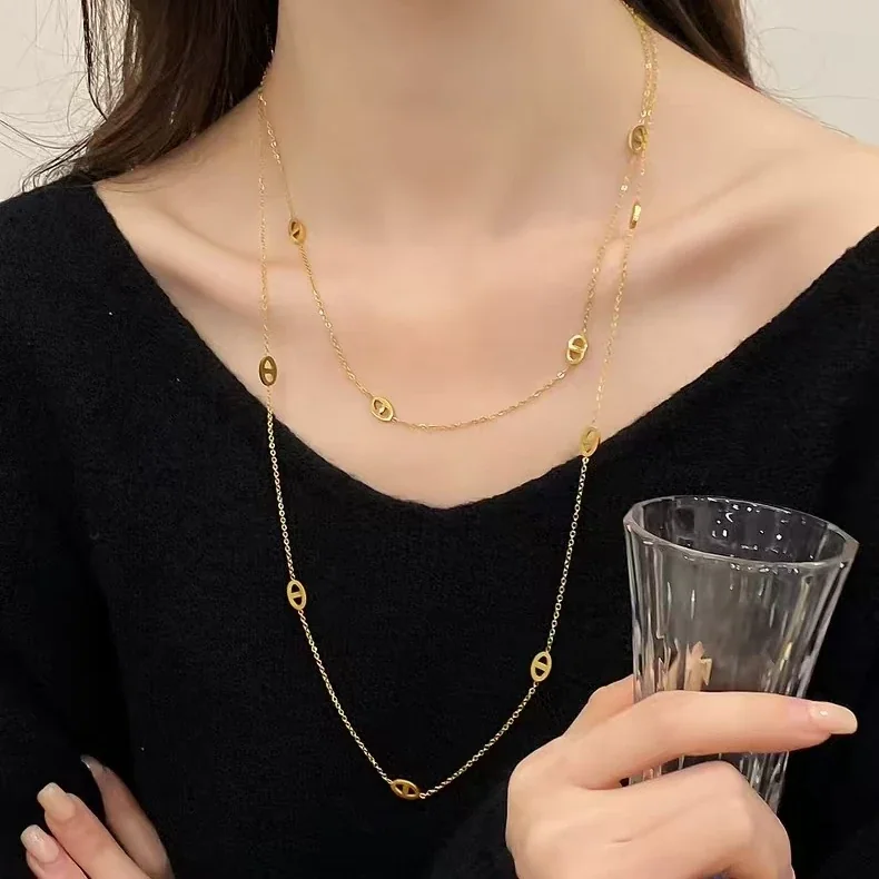 Gelaagde ketting met ovale openwerkmotieven, verguld productfoto