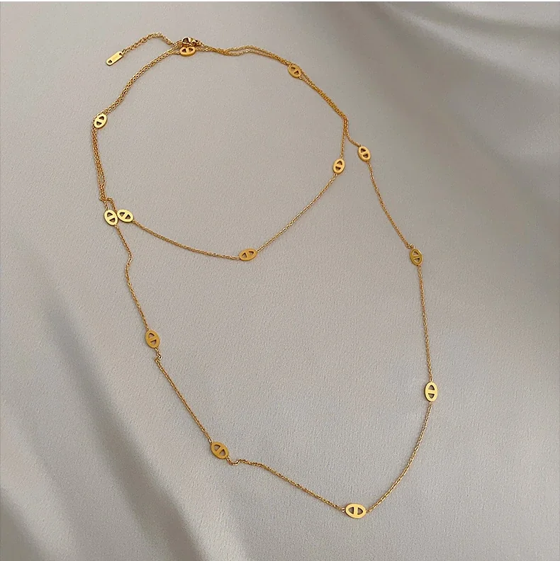 Gelaagde ketting met ovale openwerkmotieven, verguld productfoto