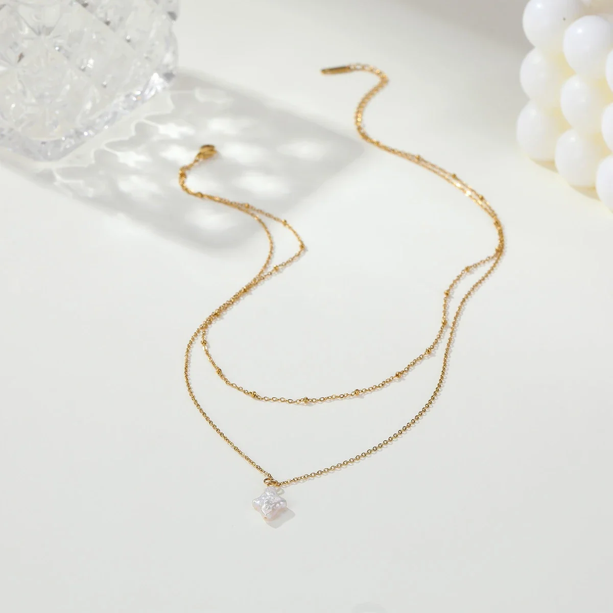 Gelaagde ketting met sterparel en 18K-vergulding productfoto