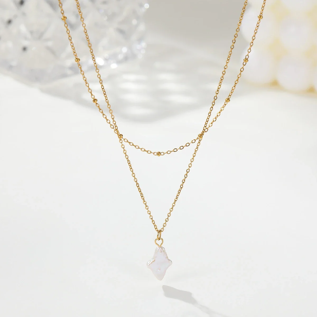 Gelaagde ketting met sterparel en 18K-vergulding productfoto