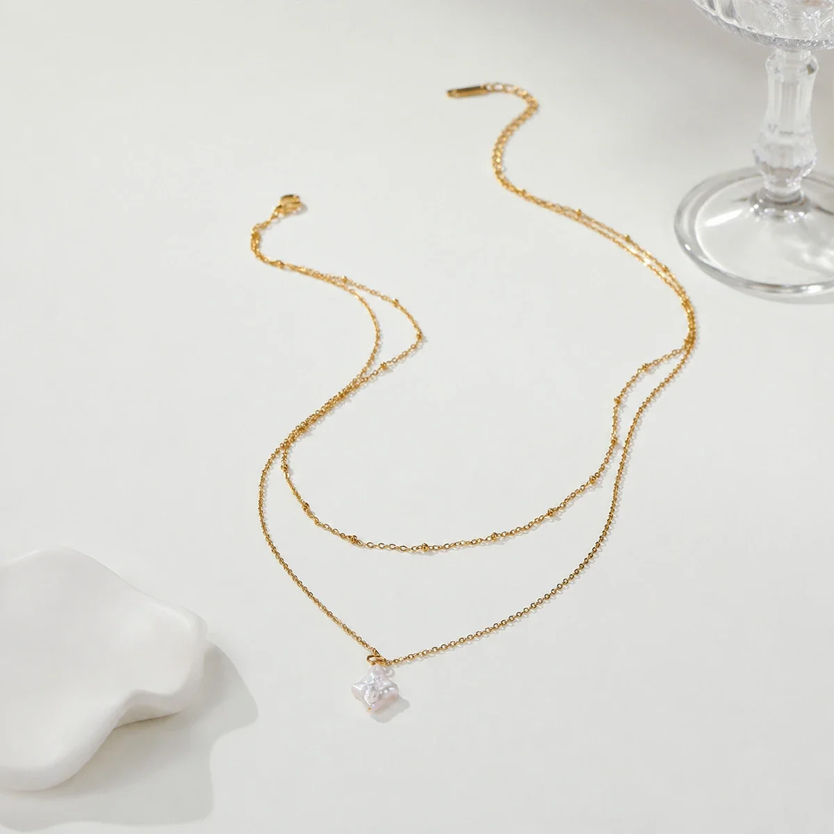 Gelaagde ketting met sterparel en 18K-vergulding productfoto